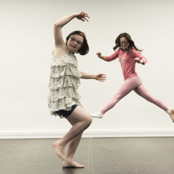 Two young girls dancing.