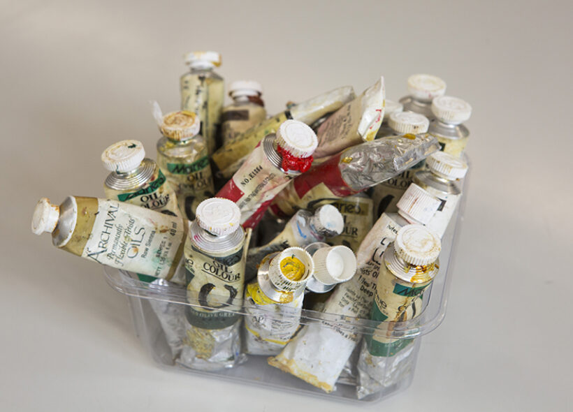 artists' paint tubes in a clear container