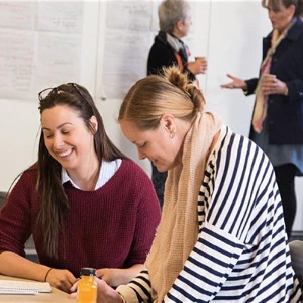 people smiling, people sitting and standing. 