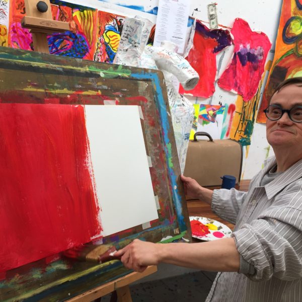 Visual artist painting in studio. 