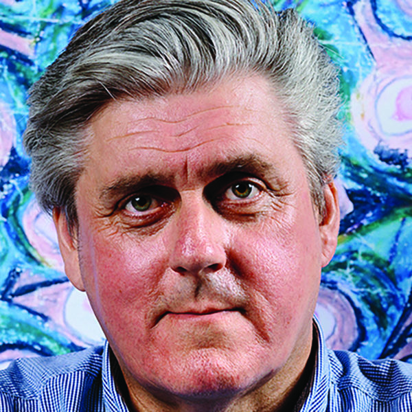 The face of a person with a background of eyes drawings 