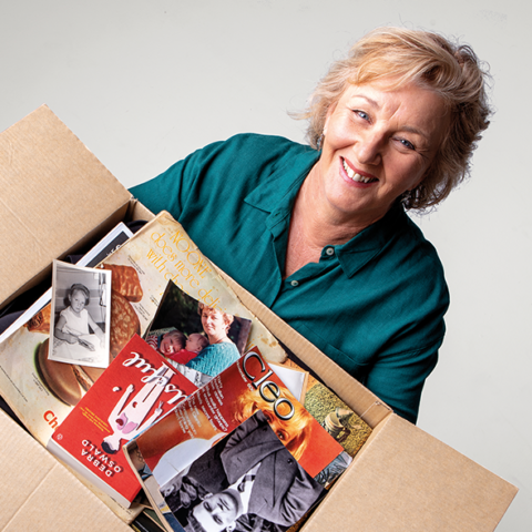 Woman holding box of magazines