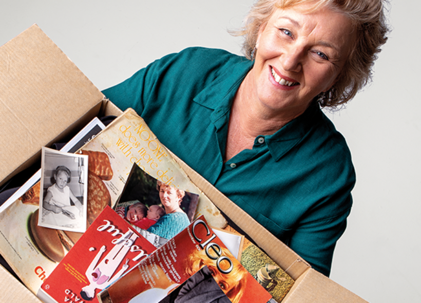 Woman holding box of magazines