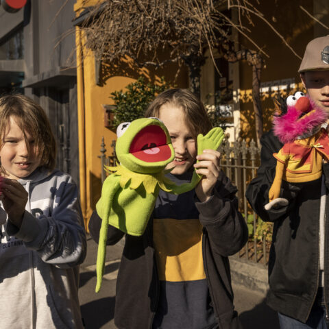 three kids with a puppet each