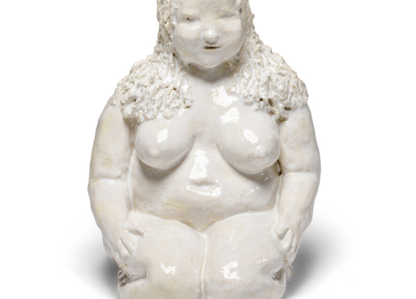 white ceramic sculpture of lady kneeling