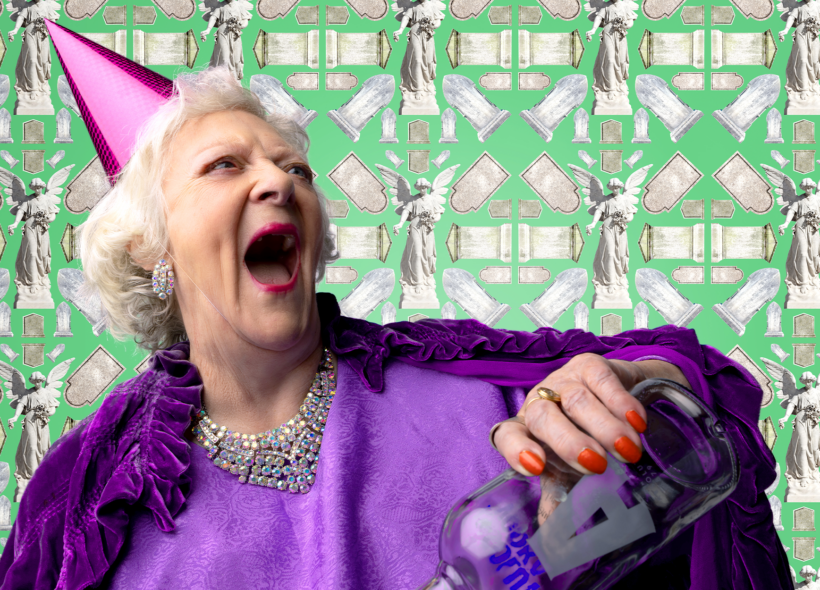Elderly lady wearing a purple party hat, holding a bottle of vodka and laughing. 