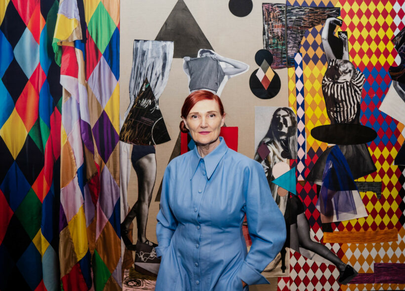 Portrait of Sally Smart standing in front of artwork