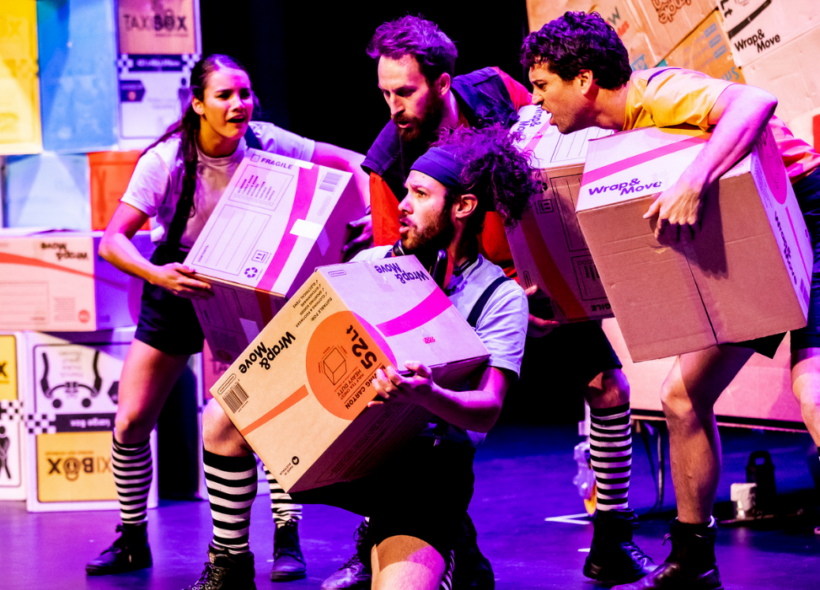 The actors onstage perform with their array of boxes 