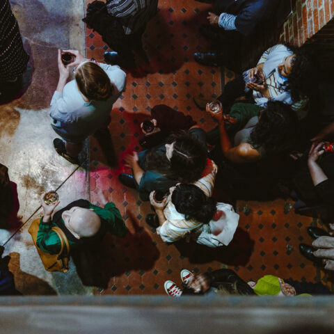 Aerial shot of a crowd holding drinks in the foyer at The Substation