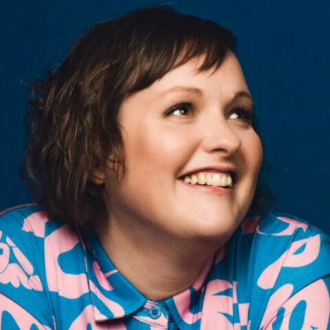 Head shot of Josie Long, smiling into the distance.