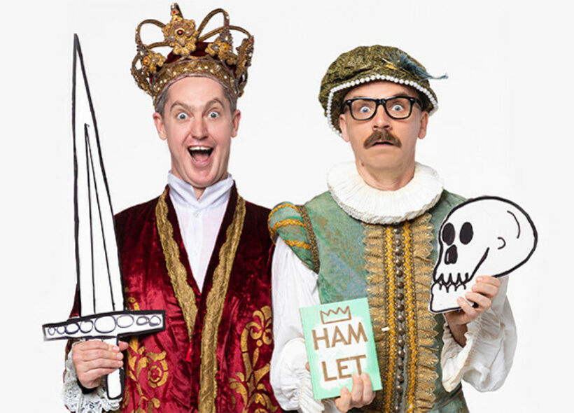 Two actors in Shakespearean garb holding paper props of a sword, a skull, and the book Hamlet