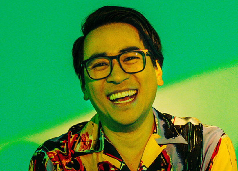 Headshot of Michael Hing in a very patterned shirt smiling at the camera