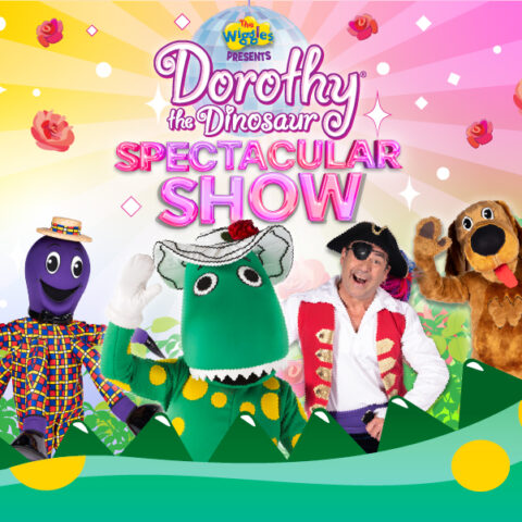 Colorful Wiggles show banner featuring characters Henry the Octopus, Dorothy the Dinosaur, Captain Feathersword, and Wags the Dog in front of a whimsical background with flowers and hills.