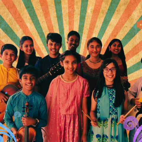 Members of The Korma Kids Youth Orchestra posing with their instruments on a vibrant coloured backdrop.