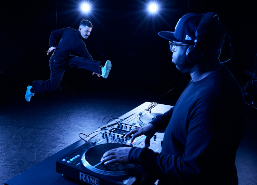 A DJ and a Hip Hop artist dancing.