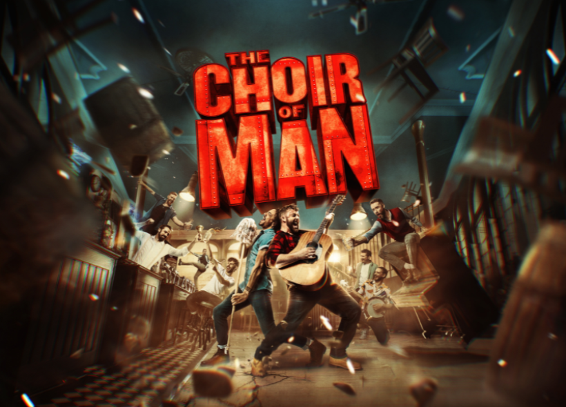 A lively scene in a bar shows two men in the foreground, one singing into a mop handle and the other playing an acoustic guitar. Text reads 