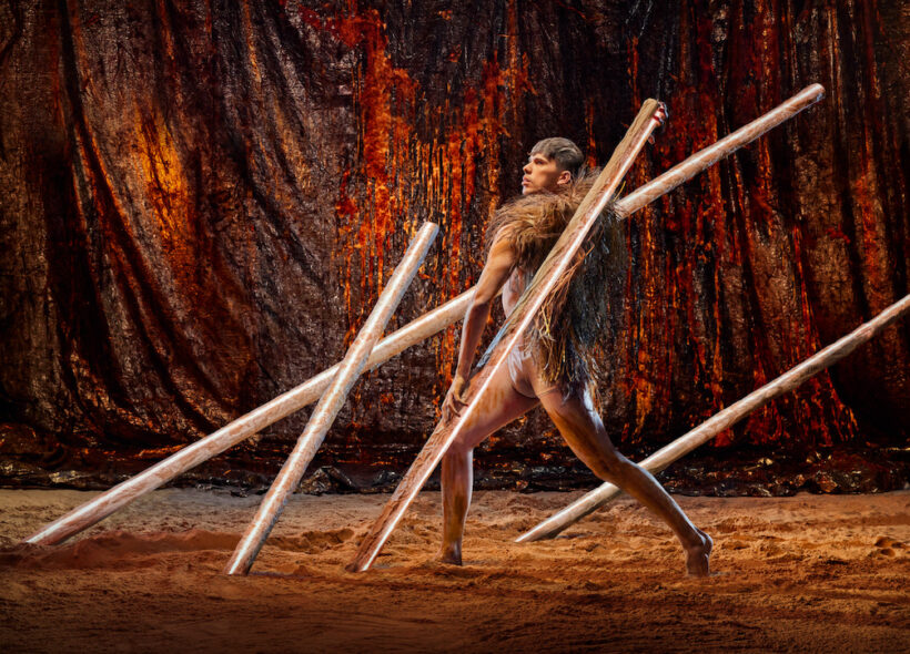 Bangarra dancer surrounded by large sticks