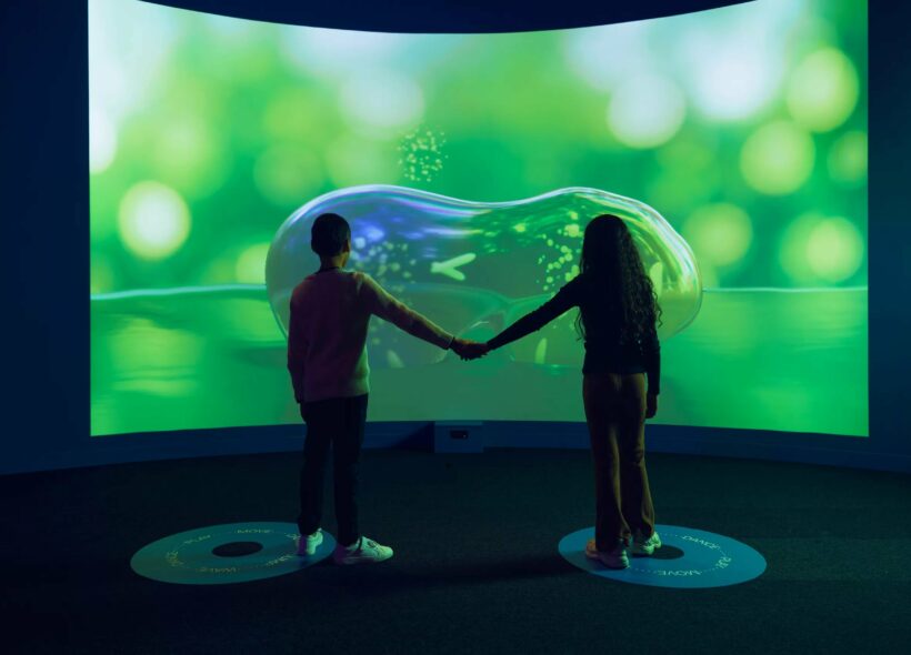 Two visitors in front of Symbiosis, an artwork in ACMI's Beings exhibition