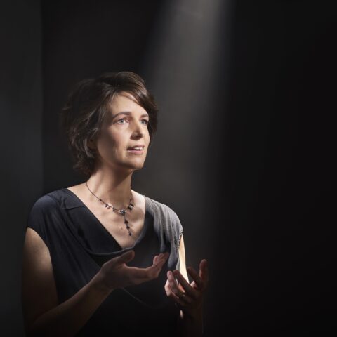 Susannah Lawergren sings with a spotlight lit on her