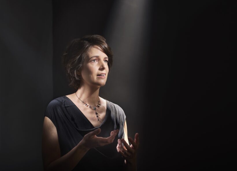 Susannah Lawergren sings with a spotlight lit on her