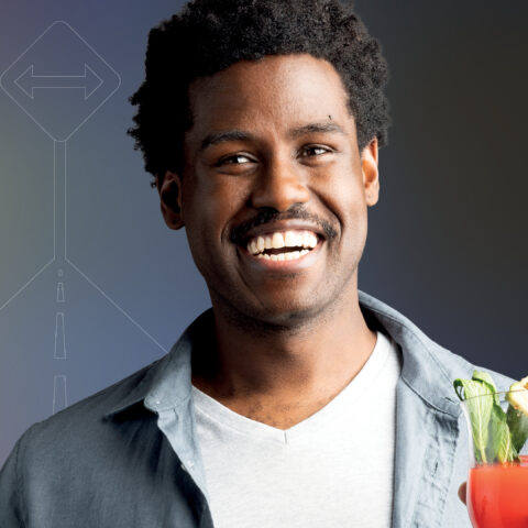 man holding cactus smiling