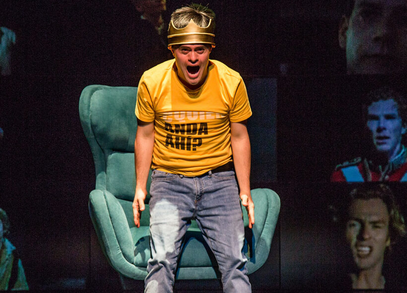 Male actor wearing crown playing Hamlet screams at audience 