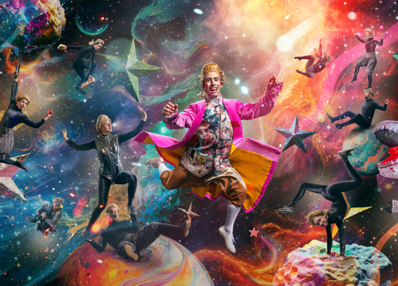 man in bright pink suit jacket floating in front of space background