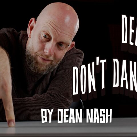 A bald, bearded man leans over a table, making his fingers “walk (or dance)” like legs. The background is black, and stylised white text reads “Dean, Don’t Dance! By Dean Nash.” Additional text shows dates “20–25 January” and the logo for Old Fitz Theatre.