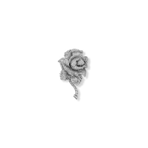 A photograph of a brooch in teh shape of a rose, with small diamonds covering every surface. 
