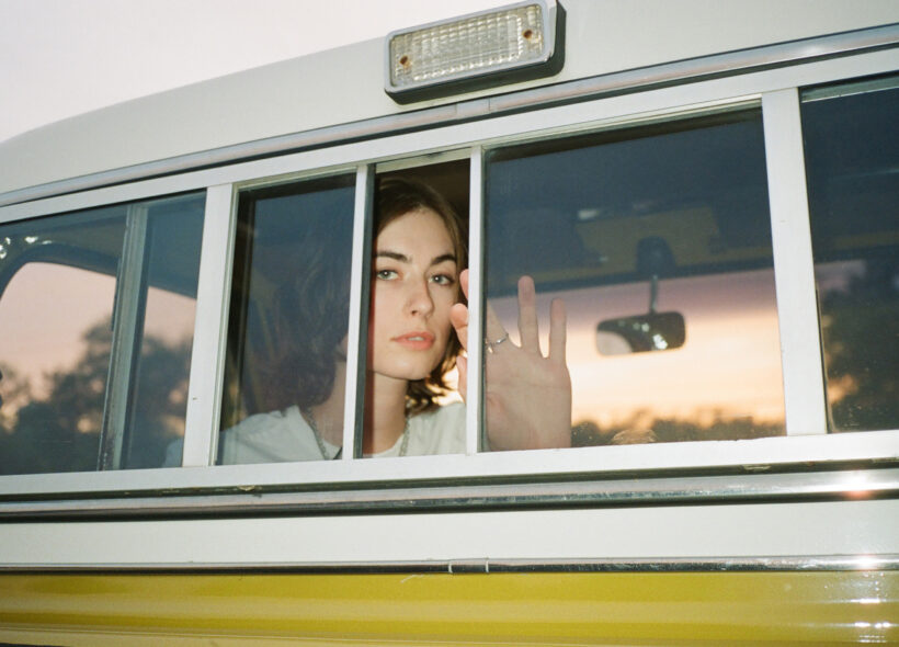 Canadian-American sound artist and composer claire rousay stares to camera while seated in a vintage car