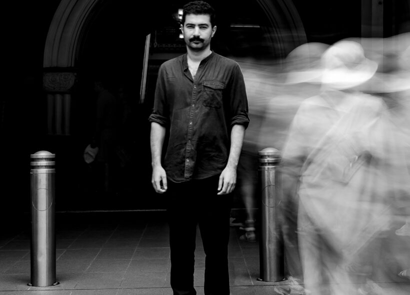 Hamed Sadeghi standing in front of an arched entrance