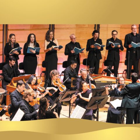 a choir performs behind an orchestra on stage 
