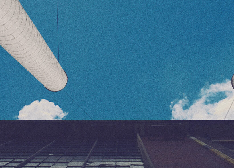 building and pipes reaching towards a blue sky 